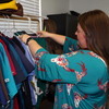 NECAC Monroe County Service Coordinator Shelby DeOrnellis looks over nursing scrubs available to qualifying residents.