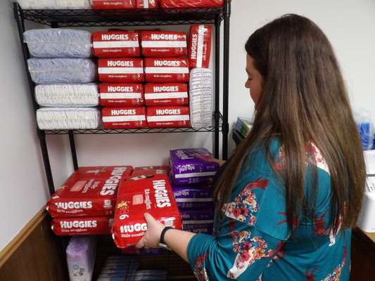 NECAC Monroe County Service Coordinator Shelby DeOrnellis looks over diapers that are available free to qualifying parents. To find out more, call DeOrnellis at 660-327-4110 from 7:30 a.m. to 5 p.m. Mondays through Thursdays.