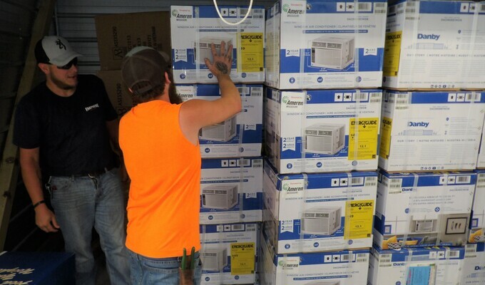 NECAC's Jesse Ohnemus and Jacob Windmiller unload air conditioners. Seventy-five units, donated by Ameren Missouri and Cool Down Missouri, are being distributed by NECAC to the elderly and disabled in nine Missouri counties.