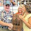 Charlie Rosenkrans accepting the recognition plaque from the 2022 Missouri State Fair Queen. Photo by Missouri Department of Agriculture.